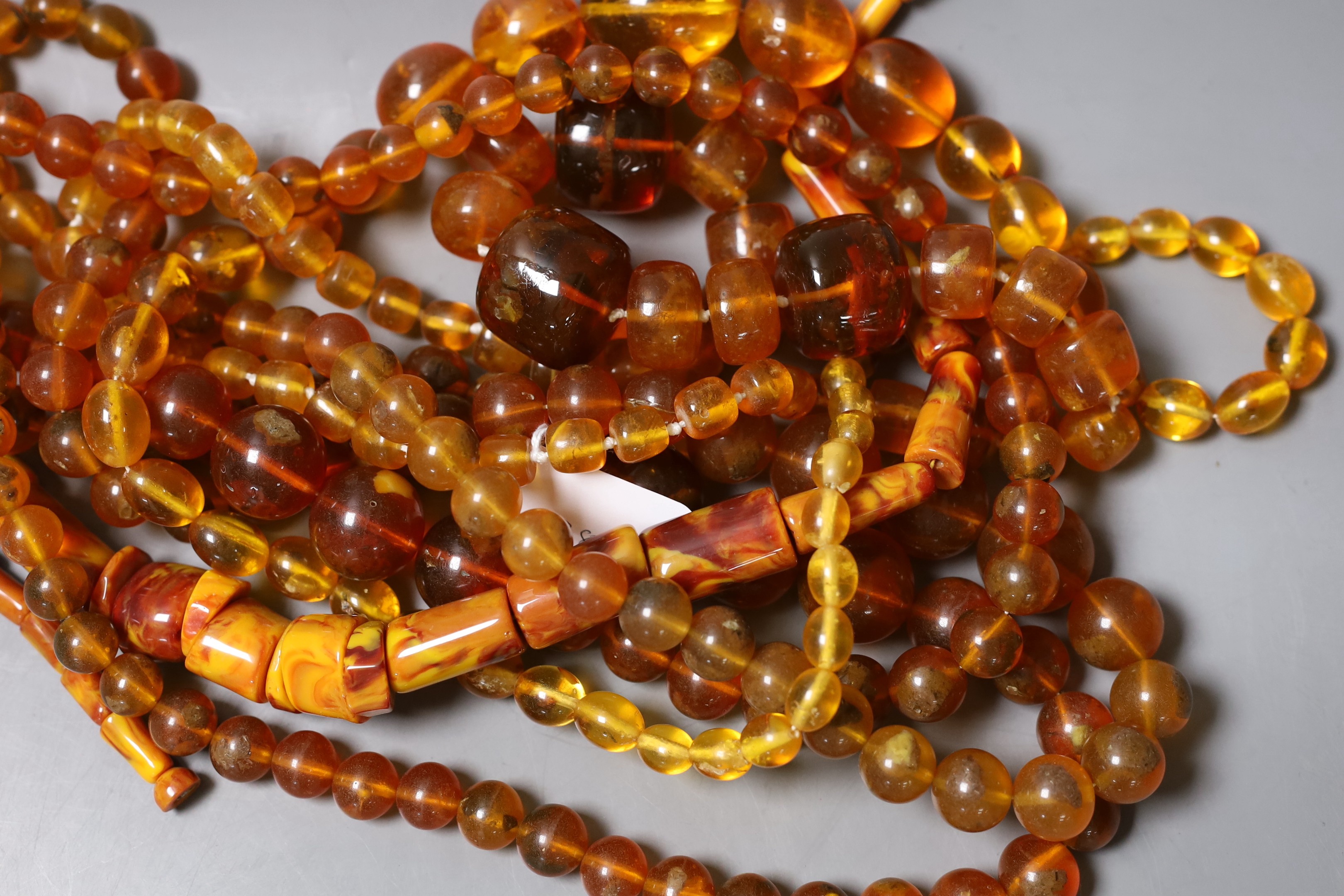 A group of amber and simulated amber bead necklaces (6).